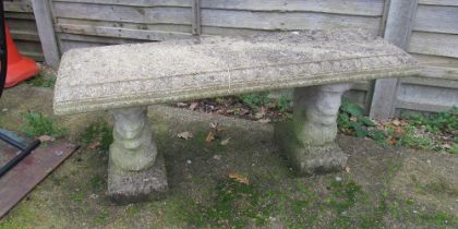 A concrete bench on twin supports