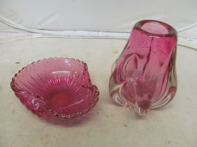 A pink glass vase and pink dish