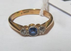 A gold ring sapphire and two diamonds