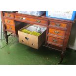 An Edwardian desk of nine drawers with shelf in recess