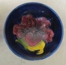 A small Moorcroft bowl blue ground with hibiscus flower