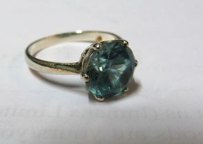 A single stone ring set blue Zircon stone (scratched)