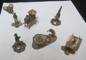 A small group of white metal oriental figures
