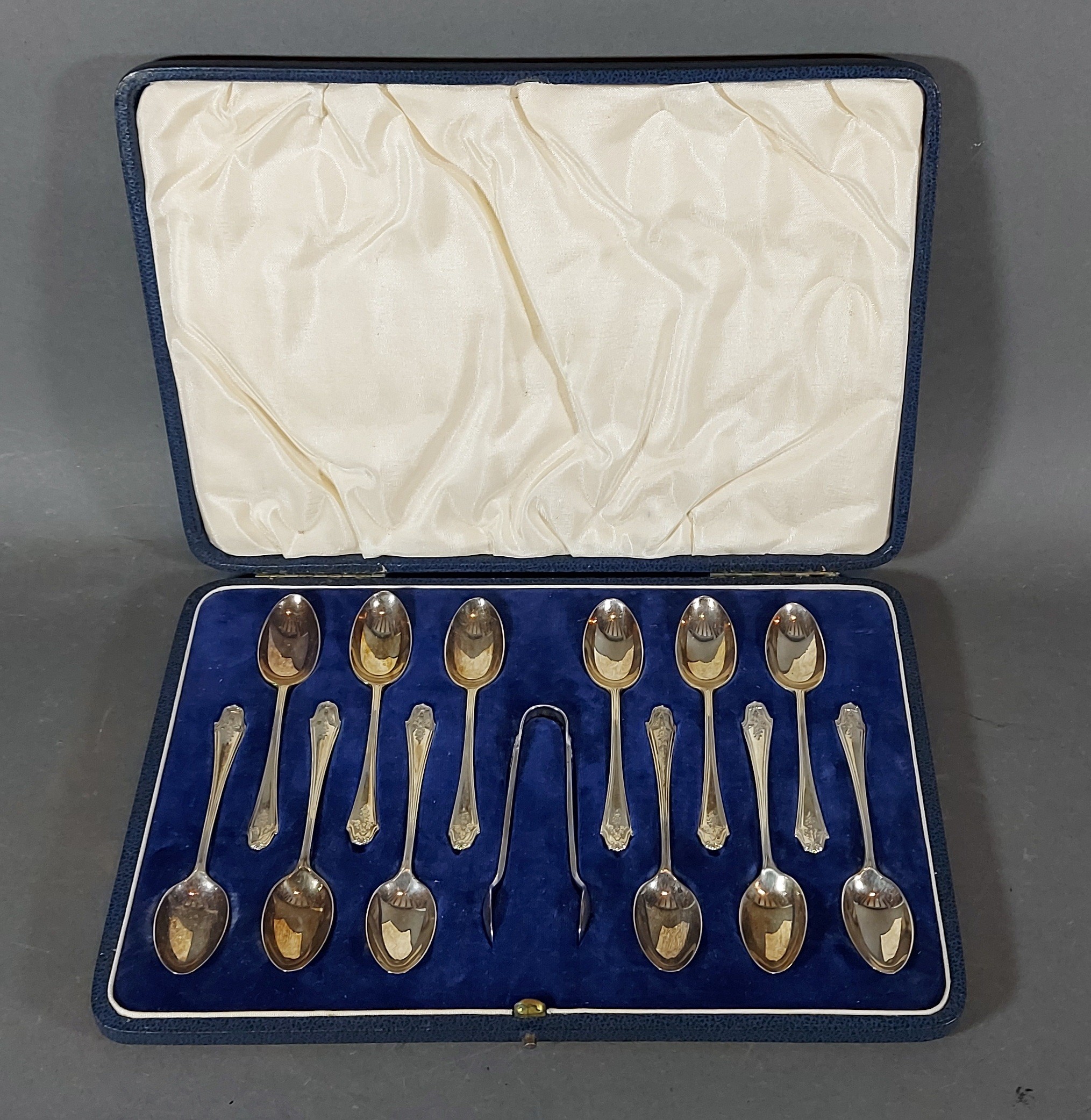 A Set of Twelve London Silver Teaspoon with matching tongs within fitted case, 5oz