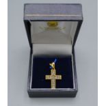 An 18ct gold diamond set crucifix pendant, 4.3 grams, 2cms long