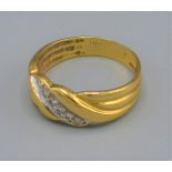 An 18ct gold diamond set band ring, with a row of six diamonds, 3.6 grams, ring size M