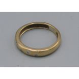 An 18ct gold wedding band set with five diamonds, 2.7 grams, ring size I