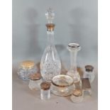 A cut glass decanter with Birmingham silver collar together with a gass spill vase with silver rim
