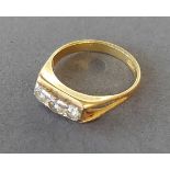 An 18ct gold ring set with three diamonds, 4gms