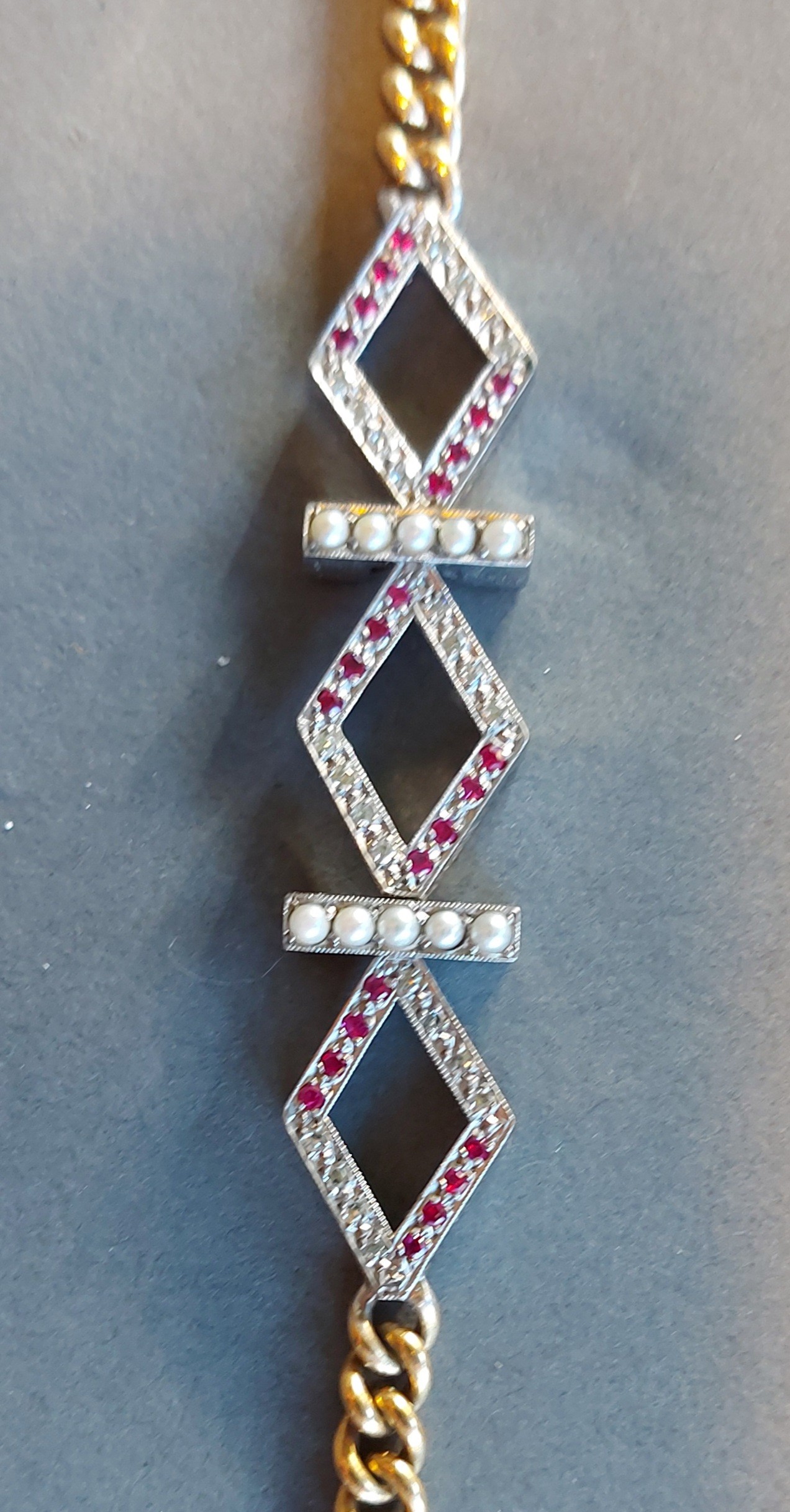An 18ct white and yellow gold Pearl, Ruby and diamond set bracelet, with central lozenge interspaced - Image 2 of 2