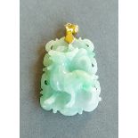 A Chinese jade pendant of pierced carved form, 4cms long