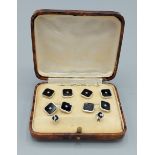 A 9ct white gold black enamel and diamond cufflink and dress stud set within fitted case