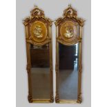 A pair of gilt framed rectangular wall mirrors each with a pierced scroll cresting above a panel