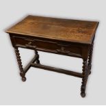 An oak side table, with a moulded drawer above barley twist supports and stretchers, 92cms wide,