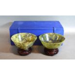 A Pair Of Chinese Jade Bowls upon hardwood stands 13.5cms diameter within fitted lined box