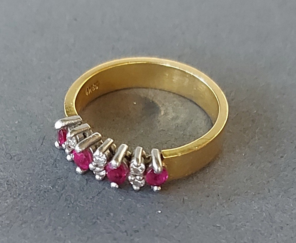 An 18ct gold Ruby and diamond set band ring, 5.2gms