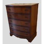 An early 20th Century walnut serpentine chest of five drawers raised upon bracket feet, 78cms