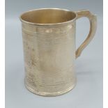 A Victorian silver mug with shaped handle, London 1864, 9ozs