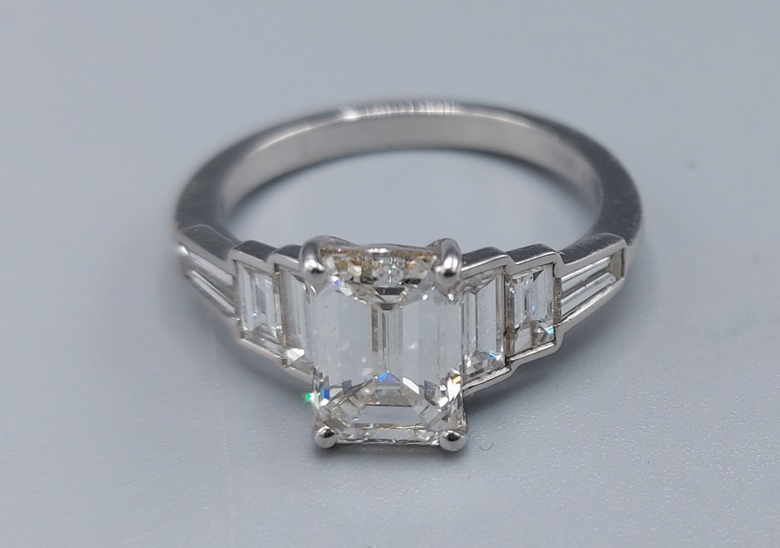 A Platinum diamond ring, the central 2.12ct Emerald cut diamond flanked by baguette diamonds - Image 2 of 3