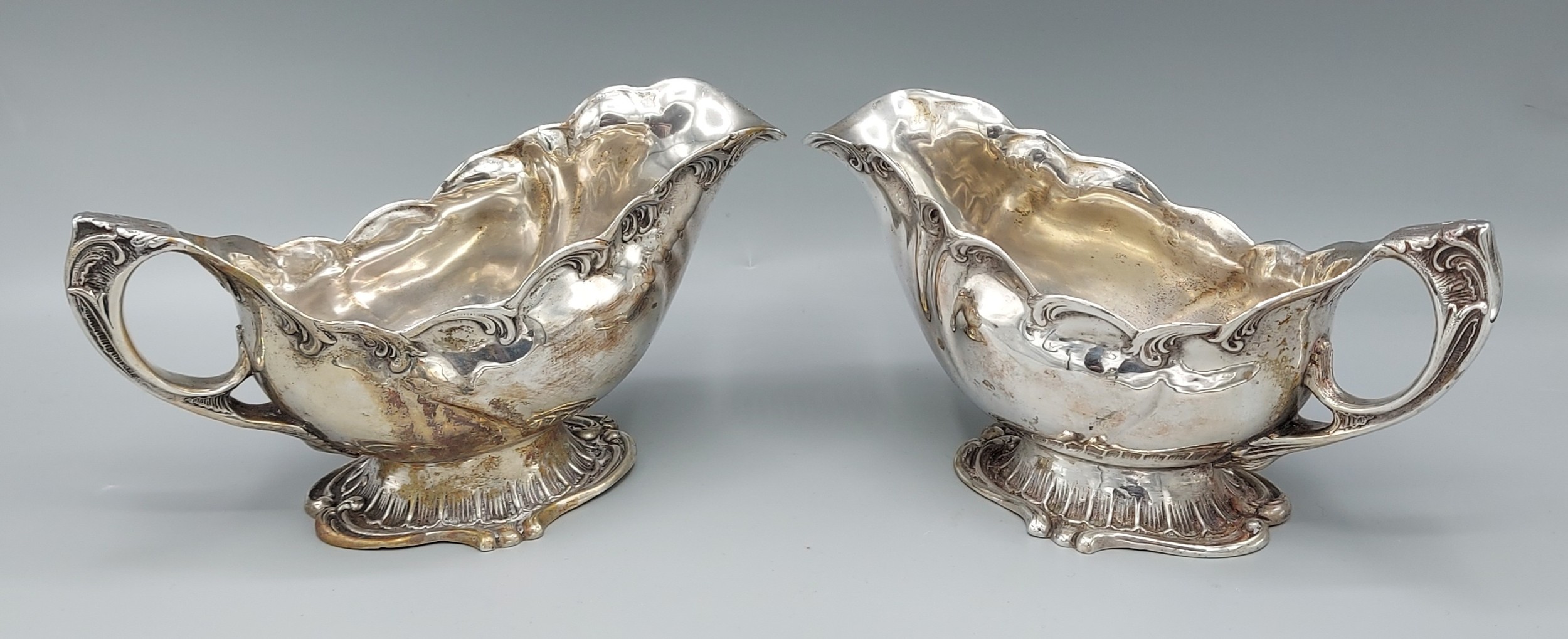 A pair of 830 silver sauce jugs of shaped form, 18ozs