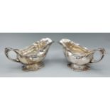 A pair of 830 silver sauce jugs of shaped form, 18ozs