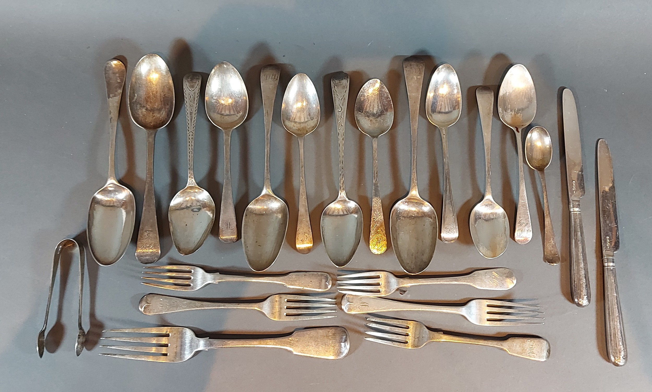 A collection of silver flatware to include Georgian Scottish silver table spoons, 30ozs