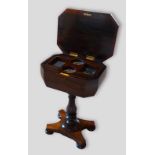 A Victorian rosewood teapoy, the hinged top enclosing a fitted interior, raised upon a turned centre