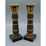 A pair of French patinated bronze candlesticks with square slate bases, 22cms tall