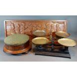 A Victorian walnut and upholstered circular footstool, together with a carven wooden wall plaque and