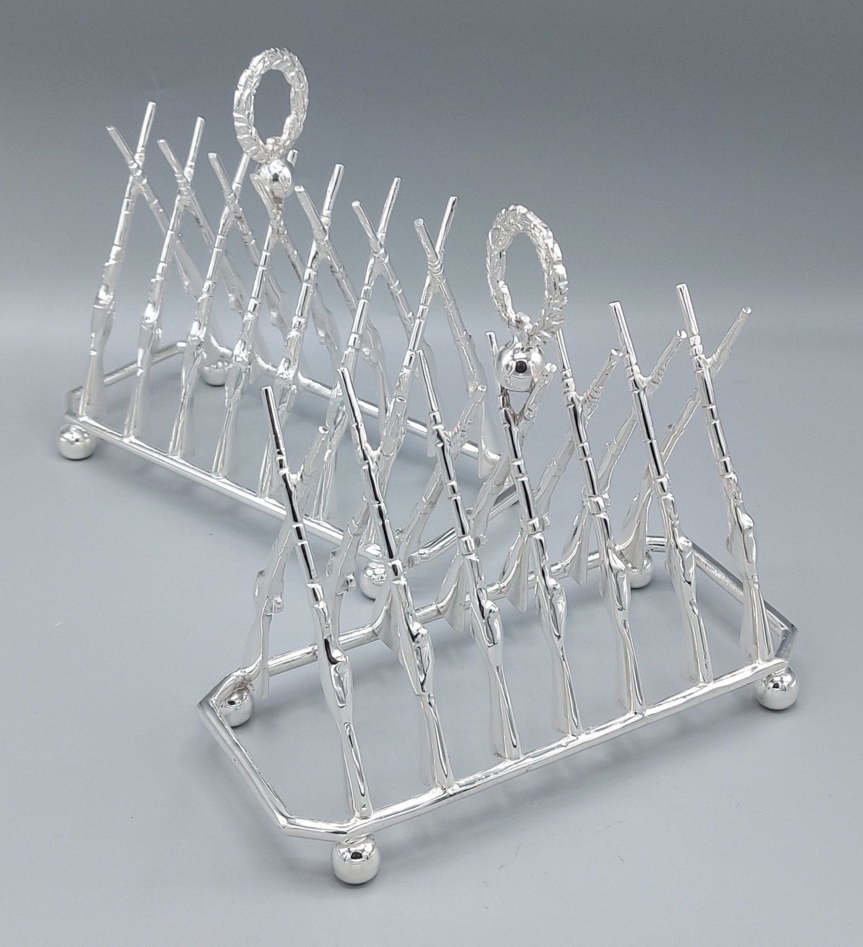 A pair of six division toast racks in the form of rifles