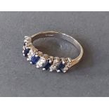 An 18ct white gold diamond and sapphire band ring set with five sapphires interspaced with diamonds,