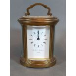 An oval brass carriage clock by Matthew Norman wthe lever escapement, 12cms tall