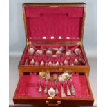 A silver plated canteen of flatware within mahogany canteen box
