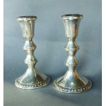A pair of Sterling silver candlesticks, 15.5cms tall
