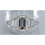 A Platinum diamond ring, the central 2.12ct Emerald cut diamond flanked by baguette diamonds