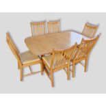 An Ercol Winsdor extending dining table, 203cms x 92cms fully extended together with six matching