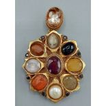 A Mughal yellow metal pendant set with semi precious stones, 33.5gms, 7cms x 4cms