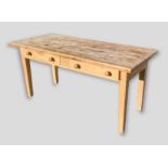 A pine farmhouse kitchen table with two frieze drawers raised upon turned tapering legs, 160cms