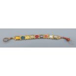 A Mughal yellow metal bracelet set with diamonds and semi precious stones, with enamel decoration to