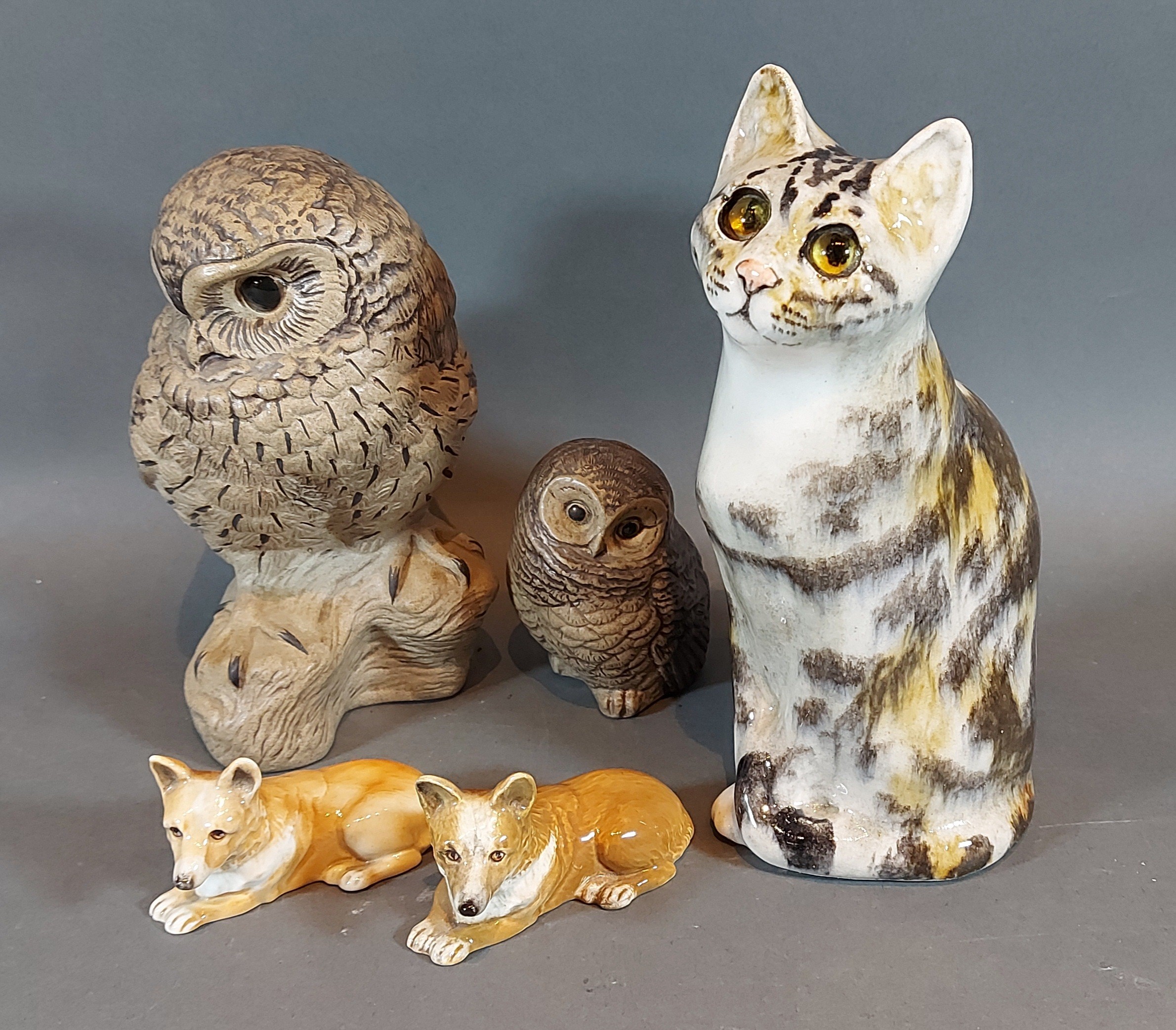 A Poole Pottery stoneware model of an owl by Barbara Linley Adams together with another similar