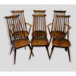 A set of six Ercol stick back dining chairs comprising two armchairs and four single chairs