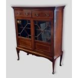 An Edwardian mahogany satinwood inlaid display cabinet with two drawers above two glazed doors