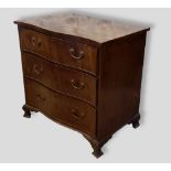 A mahogany serpentine chest of three drawers with brass handles raised upon bracket feet, 80cms