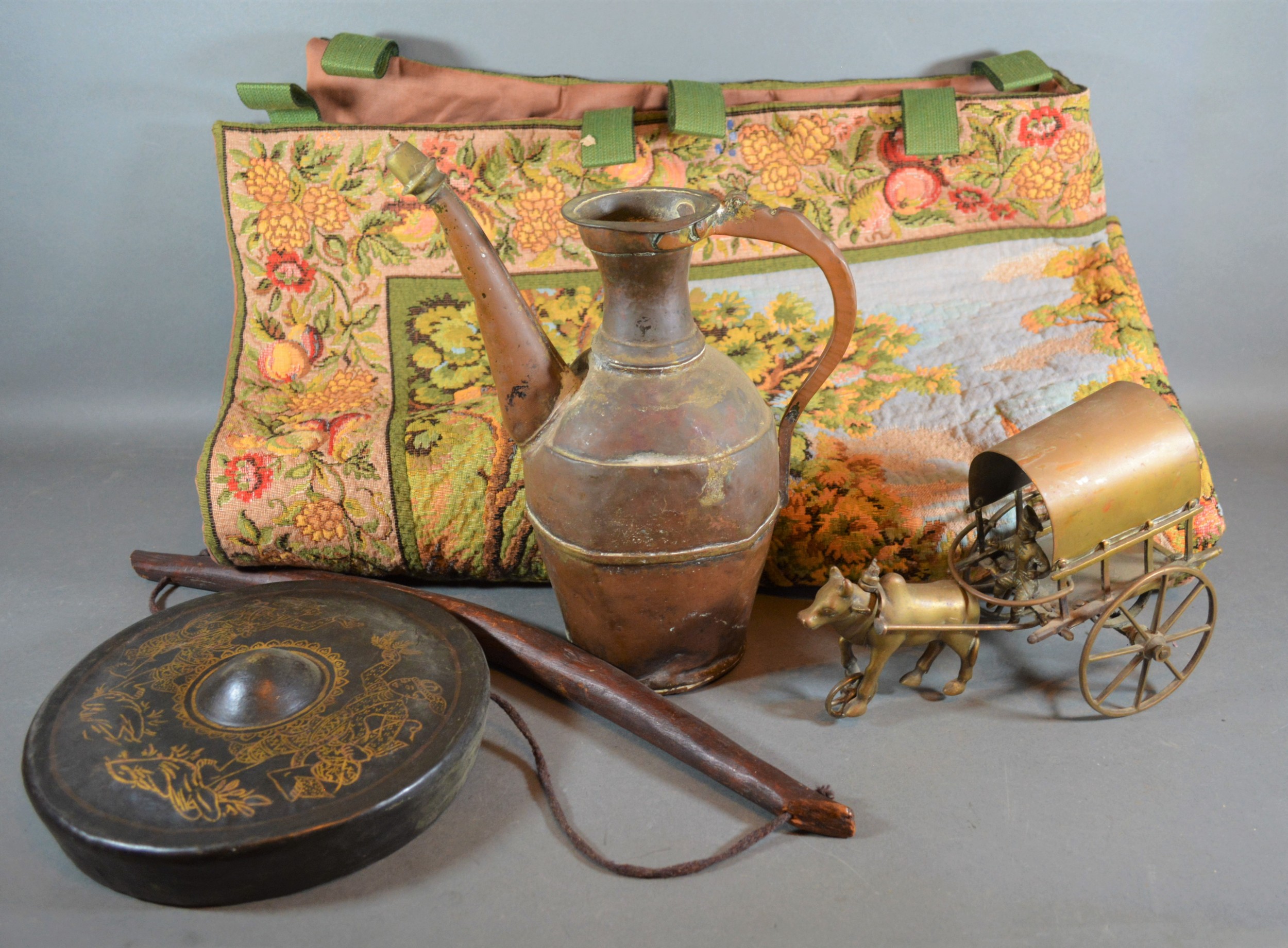 A Persian copper jug together with a Chinese small gong, a brass horse and cart, a machine made wall