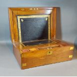 A 19th Century walnut brass banded fold over writing box, the hinged cover enclosing a fitted