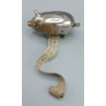 A novelty tape measure in the form of a pig, 5cm long