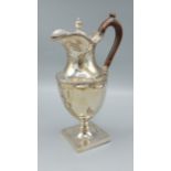 A Victorian silver claret jug of urn form with hinged lid upon square base, Sheffield 1894, 11ozs,