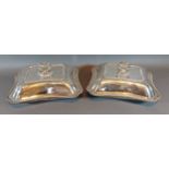 A pair of white metal entrée dishes and covers with shaped embossed handles, 95ozs