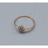 A yellow metal ring set with four small diamonds, 1gm, ring size J