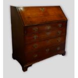 A George III oak bureau, the fall front enclosing a fitted interior above four long drawers with